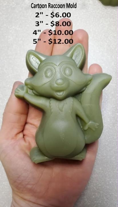 Cartoon raccoon mold, standing with arms raised and a striped tail, cast in green