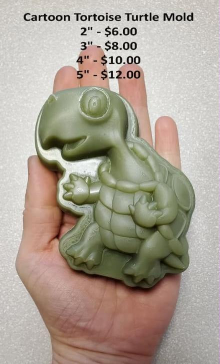 Cartoon tortoise mold with a domed patterned shell, cast in green and held in a hand