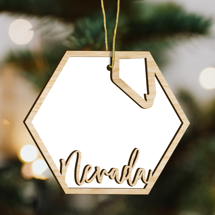 Nevada hexagon wood ornament on a tree, blank photo panel with the state outline