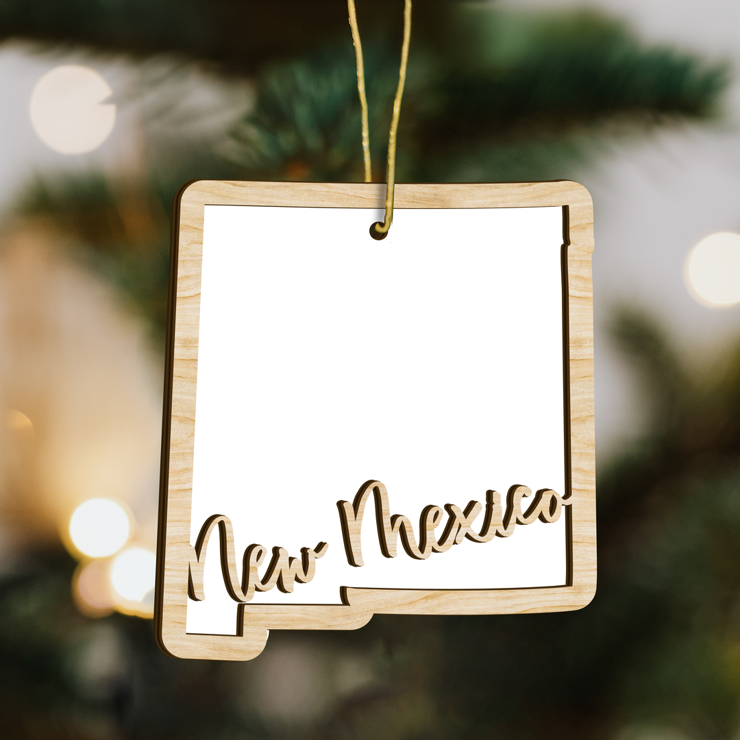New Mexico state-shape wood ornament on a tree, blank photo panel for your own picture