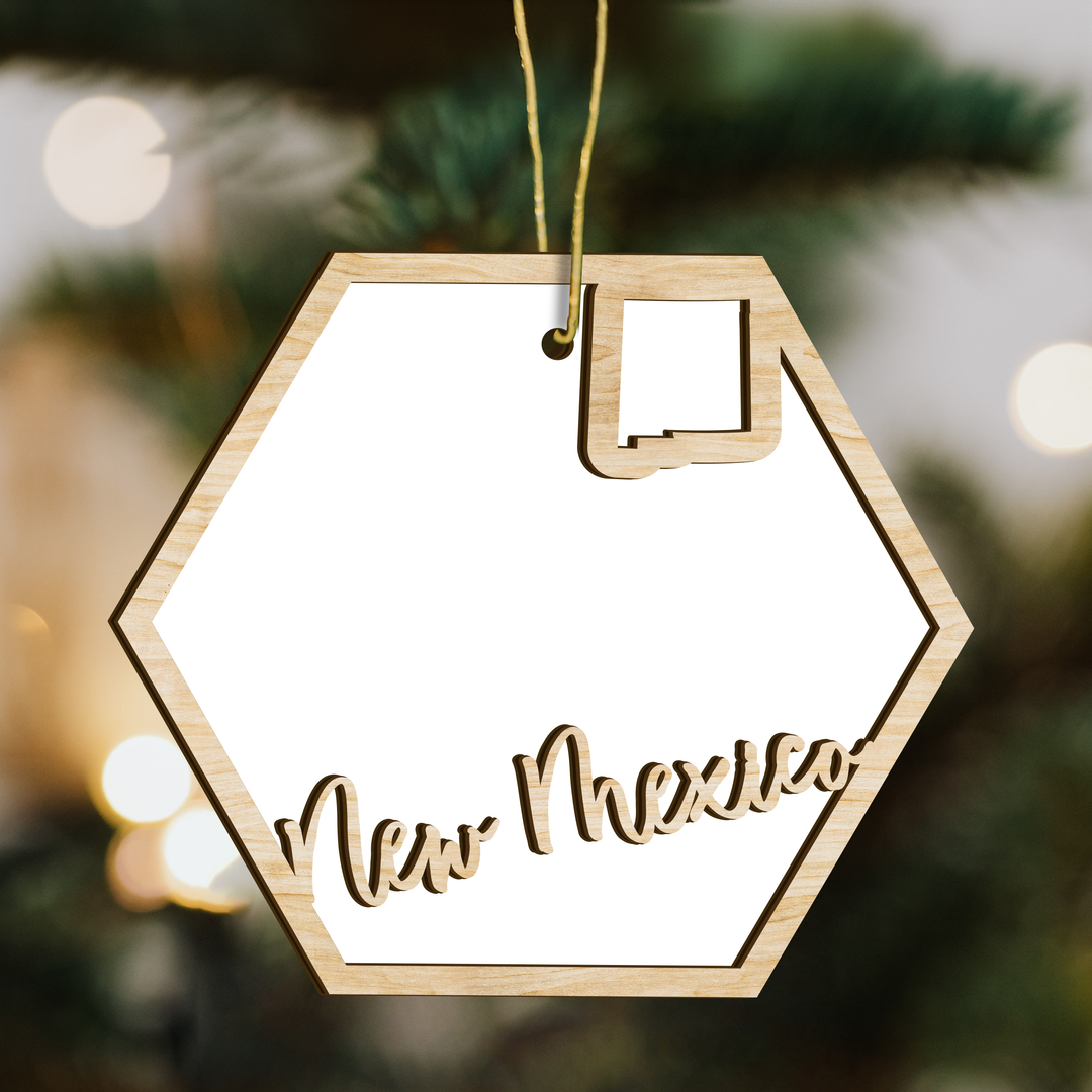 New Mexico hexagon wood ornament on a tree, blank photo panel with the state outline