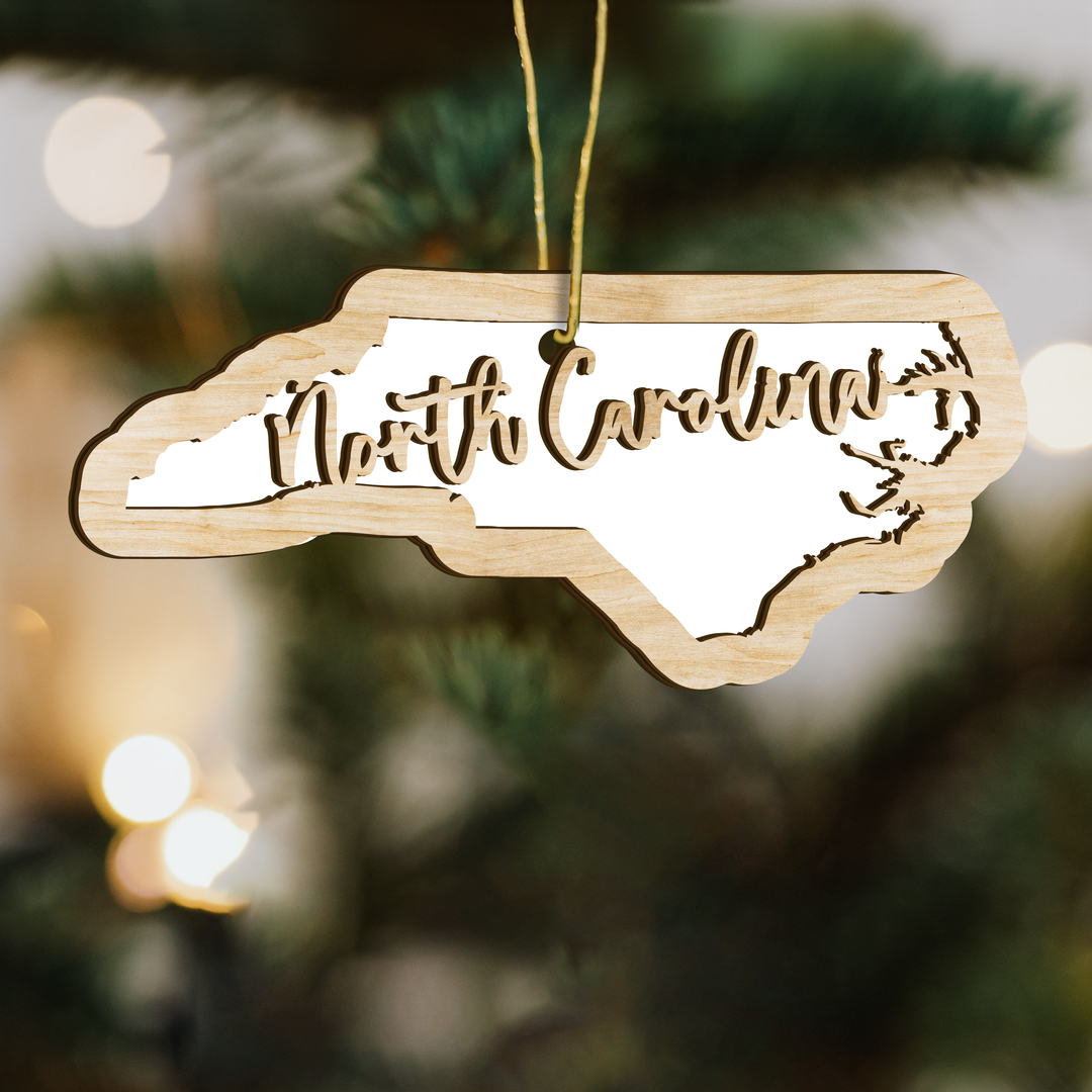 North Carolina state-shape wood ornament on a tree, blank photo panel for your own picture