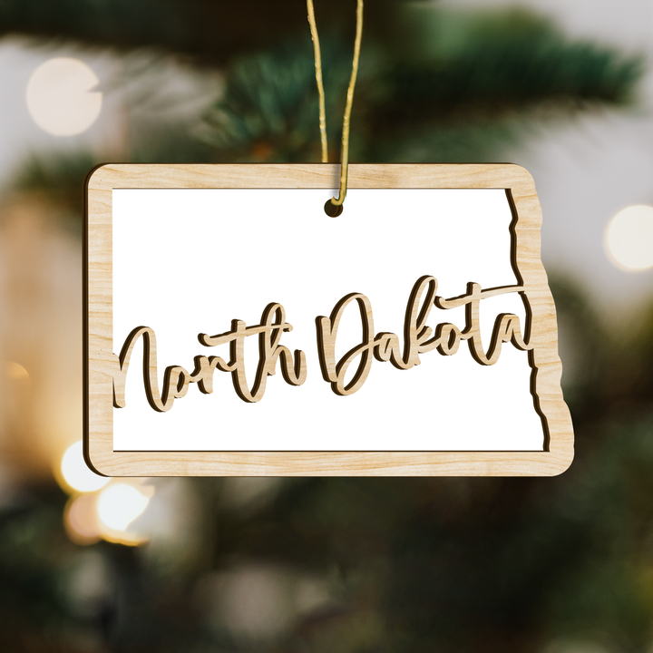 North Dakota state-shape wood ornament on a tree, blank photo panel for your own picture