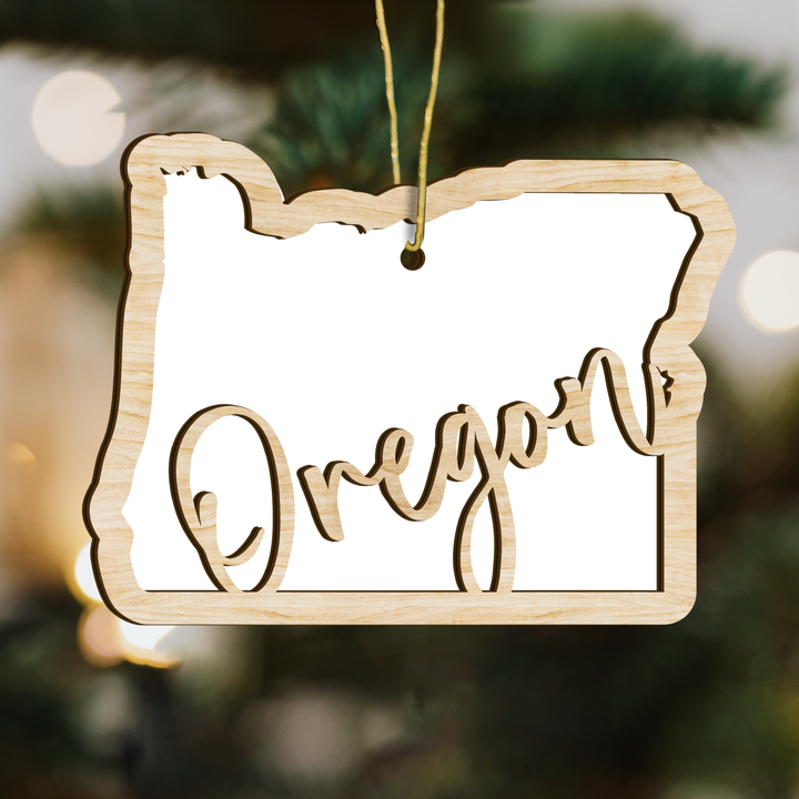 Oregon state-shape wood ornament on a tree, blank photo panel for your own picture