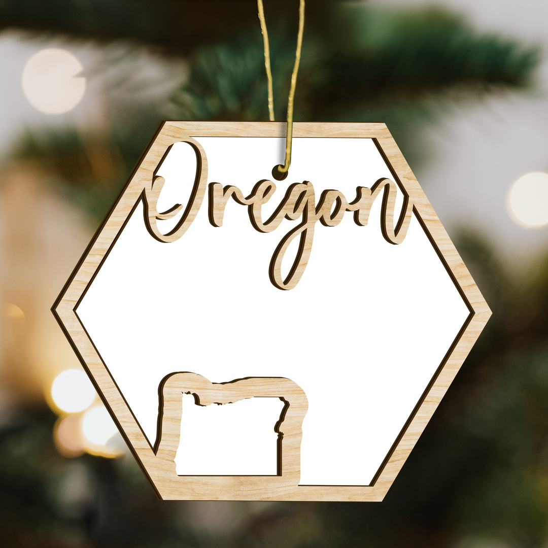 Oregon hexagon wood ornament on a tree, blank photo panel with the state outline