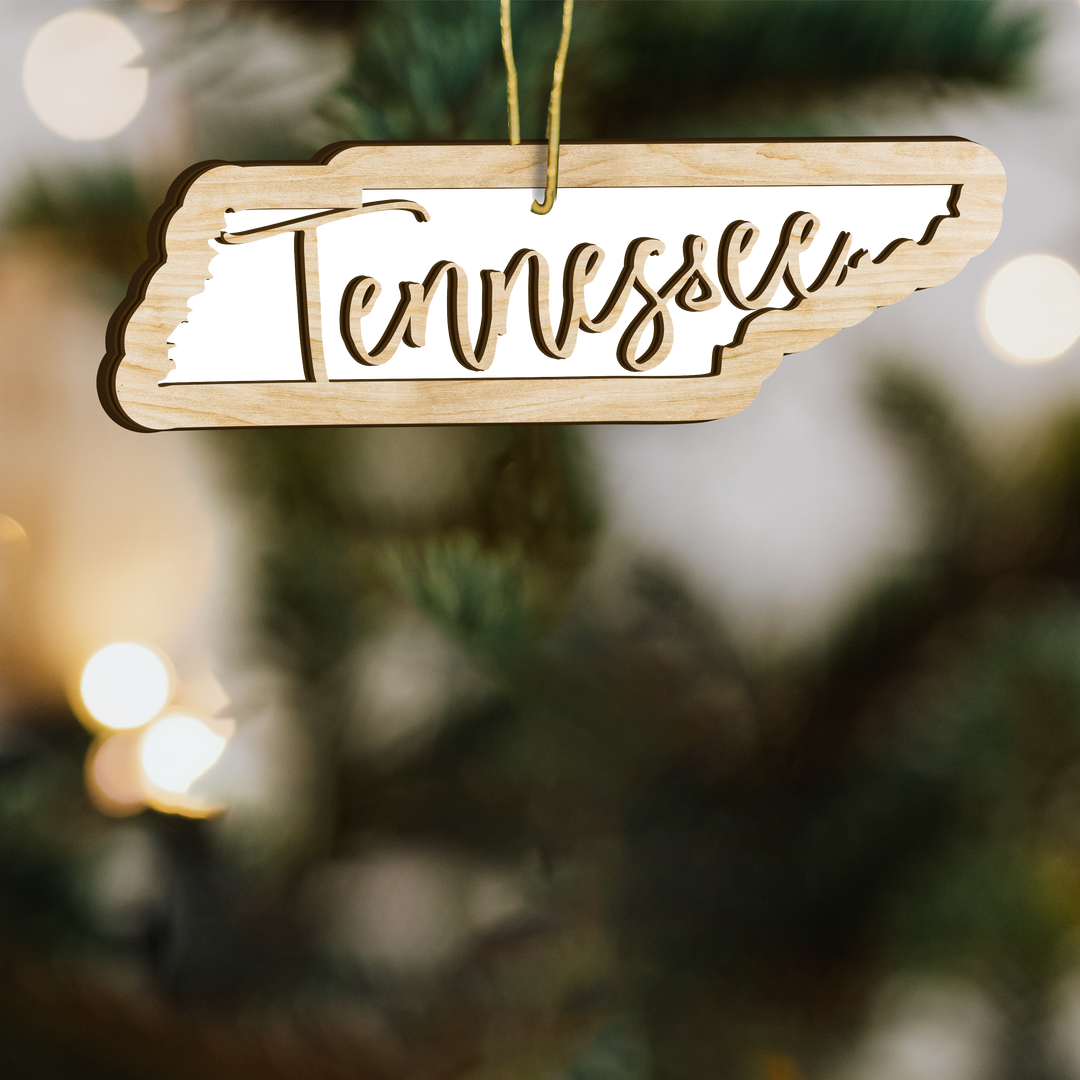 Tennessee state-shape wood ornament on a tree, blank photo panel with Tennessee in script