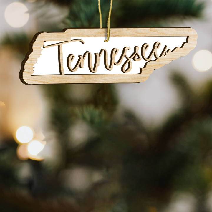 Tennessee state-shape wood ornament on a tree, blank photo panel with Tennessee in script