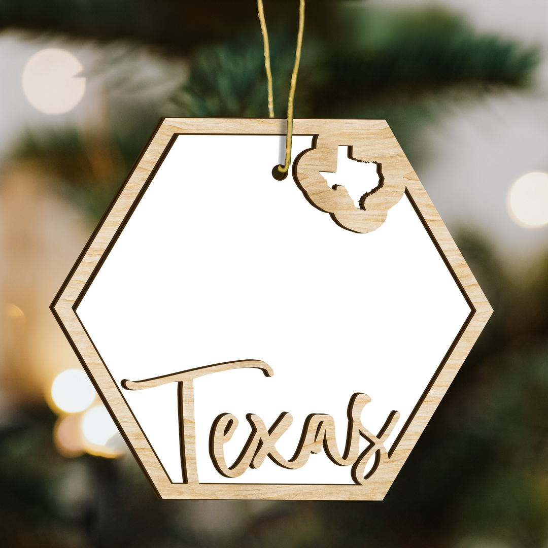 Texas hexagon wood ornament on a tree, blank photo panel with the state outline