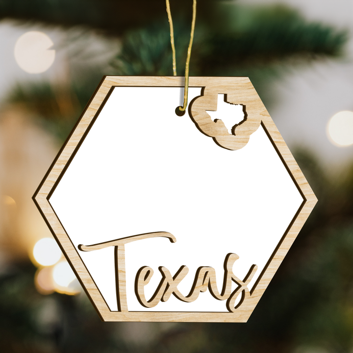 Texas hexagon wood ornament on a tree, blank photo panel with the state outline