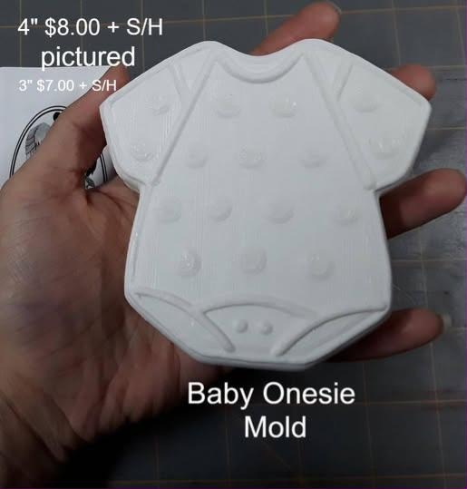 Baby onesie mold, a short-sleeved bodysuit with raised polka dots and snap fastenings