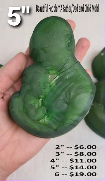 Father and child mold, a father cradling his baby against his chest, cast in green