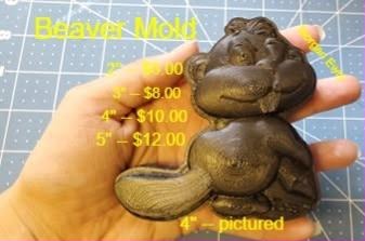 Beaver mold, a beaver sitting up with its flat paddle tail, cast in brown