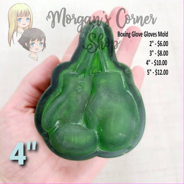 Boxing gloves mold cast in green, a pair hanging together by their laces