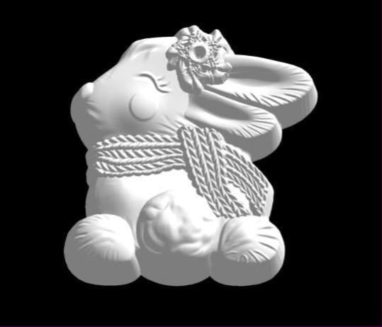 Bunny mold looking back over its shoulder in a long knitted scarf
