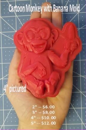 Cartoon monkey mold cast in red, a grinning monkey clutching a banana