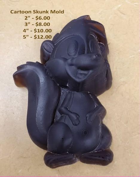 Cartoon skunk mold cast in dark brown with its striped tail arched over its back