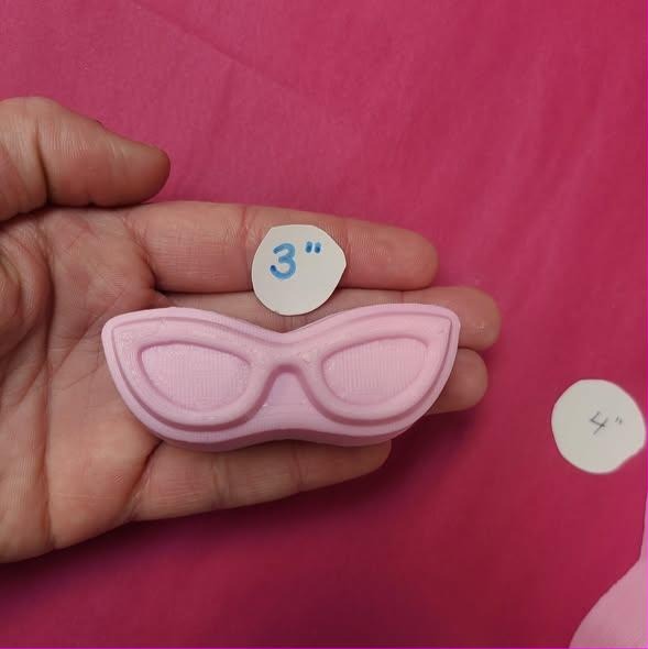 Cat eye glasses mold cast in pink, frames swept up at the outer corners