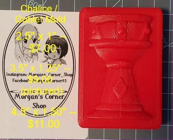 Chalice goblet mold cast in red, a stemmed cup in relief on a rectangular block