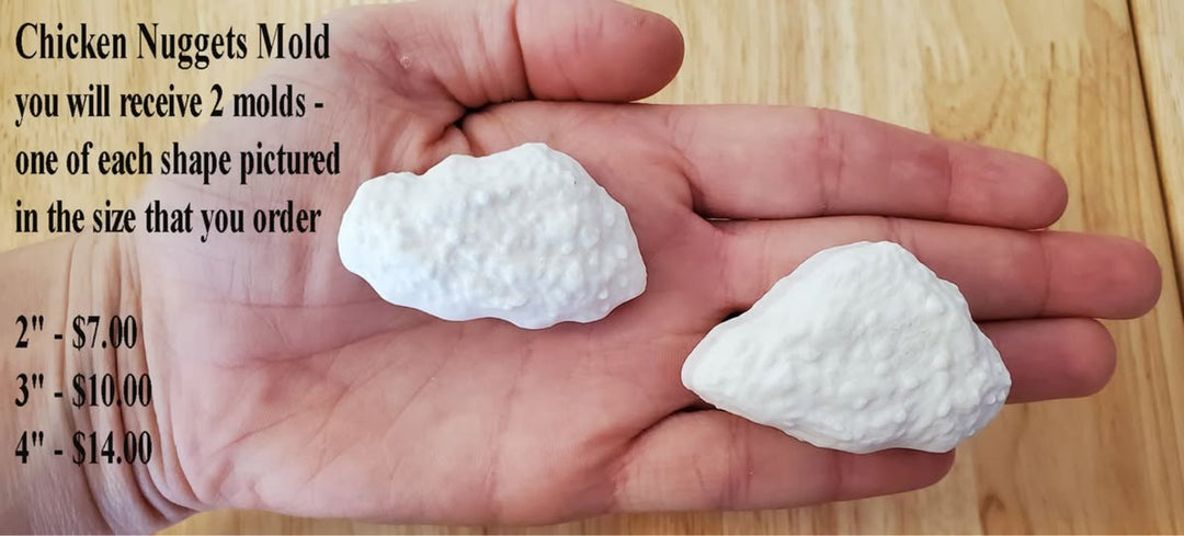 Two cast chicken nuggets held in a hand, showing both shapes included with the mold
