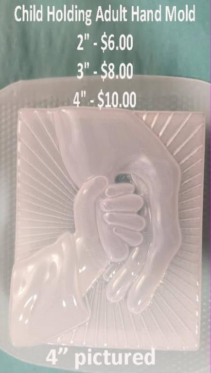 Child holding adult hand mold, a small hand around adult fingers with rays behind