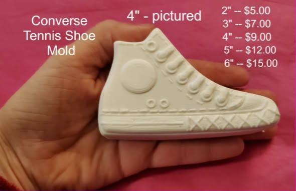 Cast of a high top sneaker showing the ankle patch, lace eyelets and striped sole