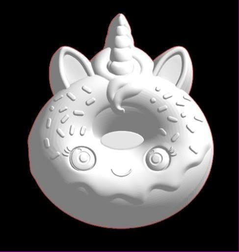 Mold of a ring donut with a unicorn horn, ears, closed eyes and sprinkles