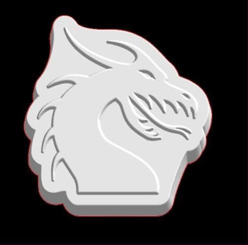 White cast of a dragon's head in profile with swept back horns and a spiked jaw