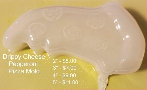Clear plastic mold of a pizza slice with pepperoni and a long drip of cheese