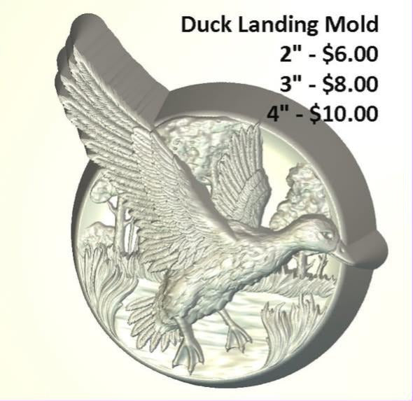 Mold of a mallard duck landing over reeds inside a round medallion