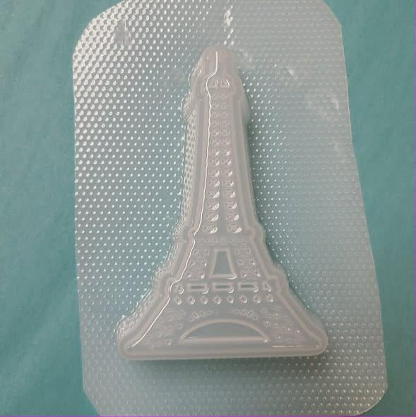 Clear plastic Eiffel Tower mold with open lattice legs, arched base and a tapering needle spire.