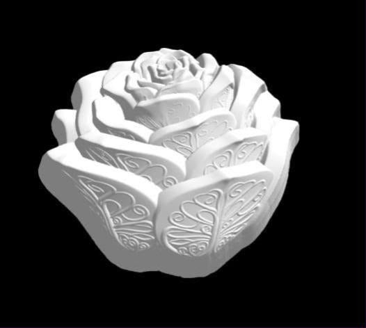 Cast rose mold with layered petals engraved in filigree scrollwork, viewed from above