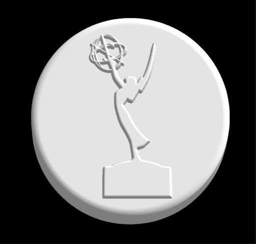 Round cast mold of a winged trophy figure on a plinth holding an atom overhead