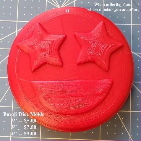 Red printed emoji disc mold master, design number one, a grinning face with raised star eyes
