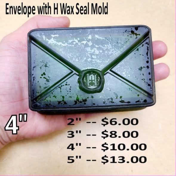 Envelope mold with crossed flap seams and a round wax seal stamped with the letter H.