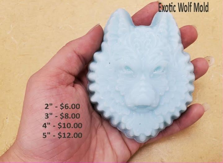 Pale blue wolf head soap cast from mold, layered fur ruff inside a beaded oval border