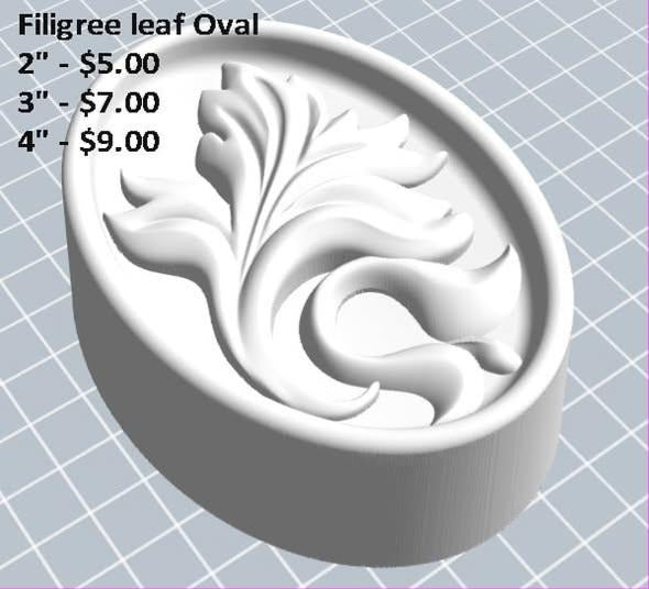 Oval filigree mold with curling acanthus leaf spray inside a raised rim on a deep round base
