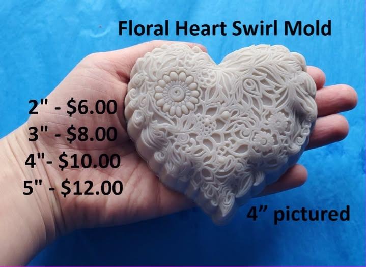 Heart mold carved with swirling vines and leaves spiralling out from a raised daisy.