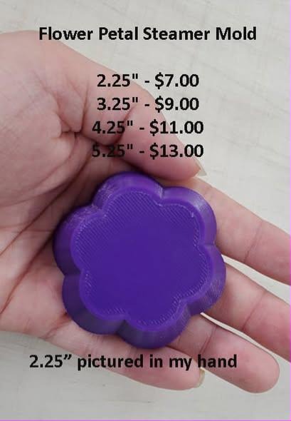 Deep purple five-petal flower steamer cast held in a hand, flat face and rounded petals