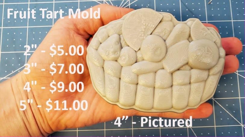 Round fruit tart mold with a deeply crimped pastry wall heaped with berries and fruit slices.