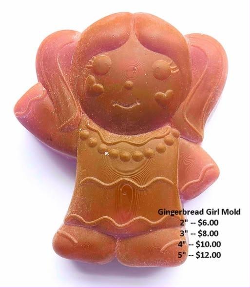 Gingerbread girl mold with pigtails, lashed eyes, a beaded neckline and scalloped dress, cast in orange-brown.