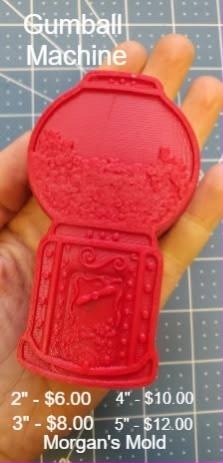 Bright red cast gumball machine with a domed globe of gumballs, coin slot and dispensing flap