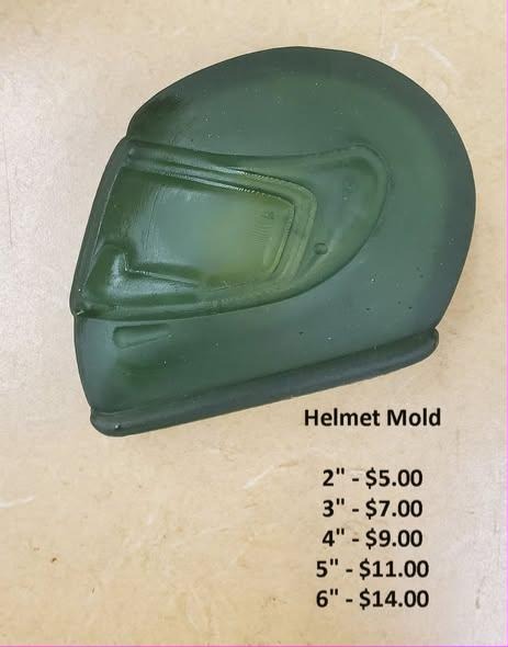 Full-face motorcycle helmet cast in dark green soap, visor down, seen from the side