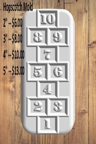 White hopscotch court cast with numbered squares one to ten, on a wooden table