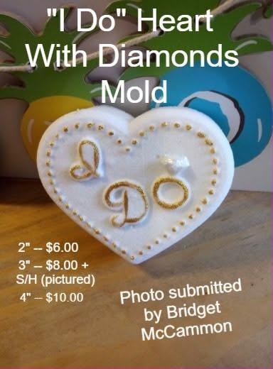 White heart cast with a dotted border and gold I Do script formed from diamond rings