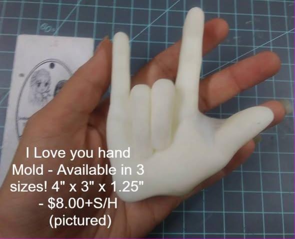 Cream cast of a hand making the ASL I love you sign, thumb, index and little finger raised