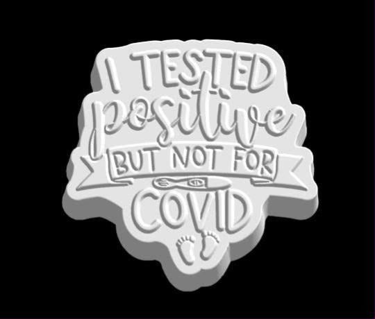 Word plaque mold reading I tested positive but not for COVID, with a test stick and two tiny baby footprints.