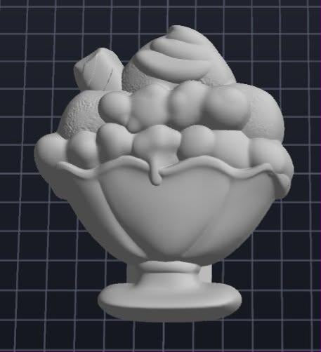 Cast mold of a footed sundae glass filled with ice cream scoops and a swirl of cream