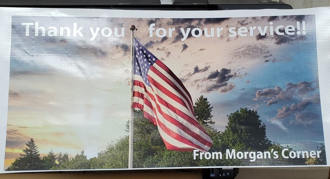 Vinyl banner reading Thank you for your service with a flag at sunset, from Morgan&