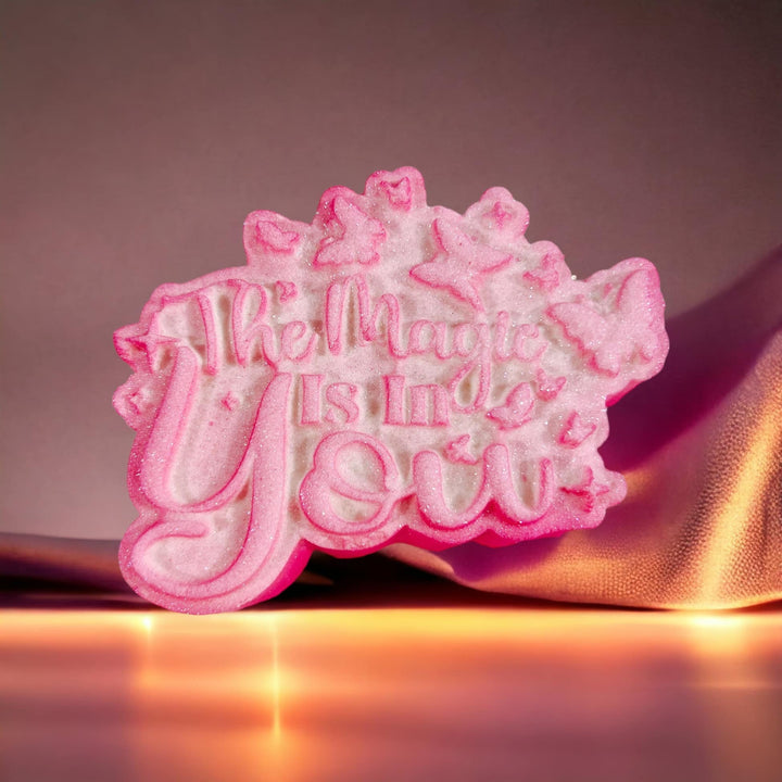 The Magic Is In You plaque cast in pink, script lettering with butterflies at one corner.