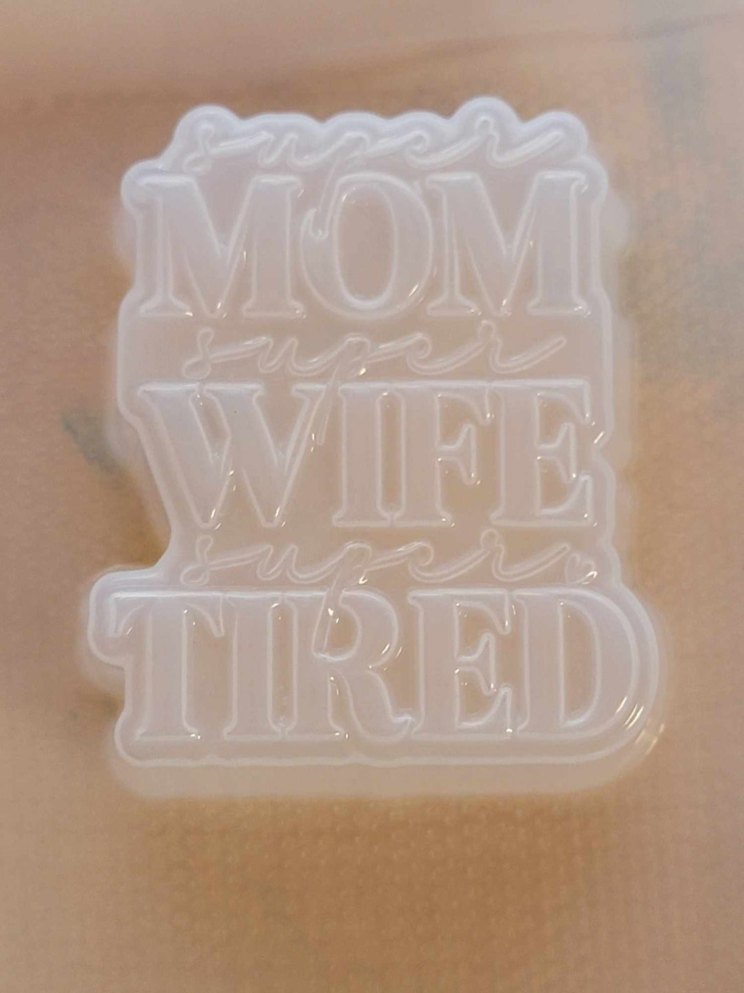 Clear plastic mold of the super MOM super WIFE super TIRED stacked lettering plaque.